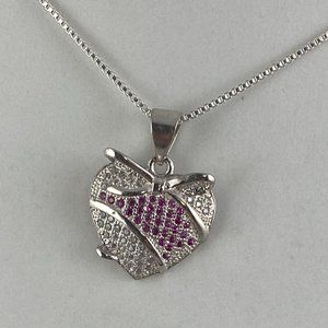 Ribbon of Rubies pass through a Heart Wrapped in a Bow Pendant Necklace